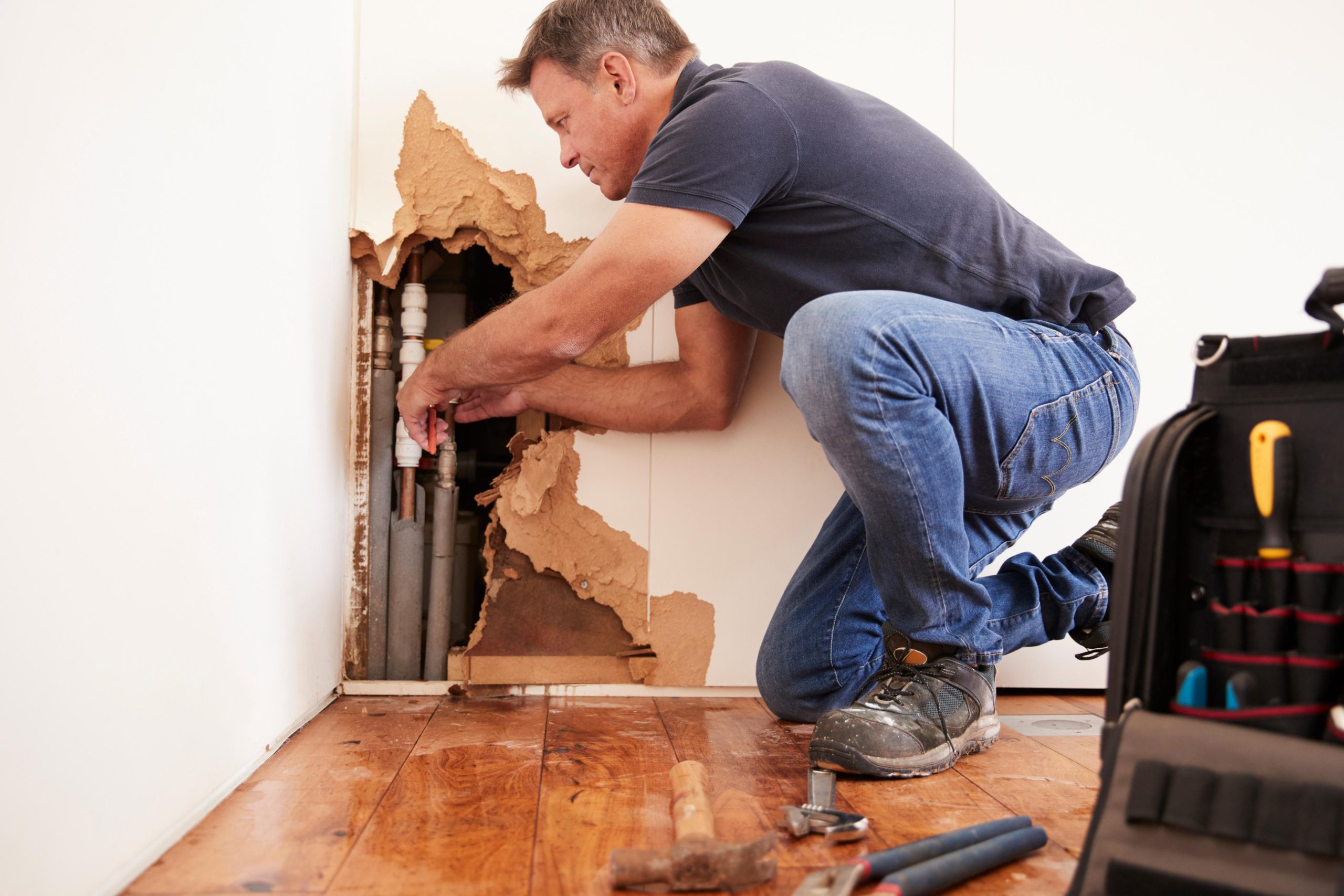 Plumber diagnosing the cause of a plumbing leak in Spokane WA