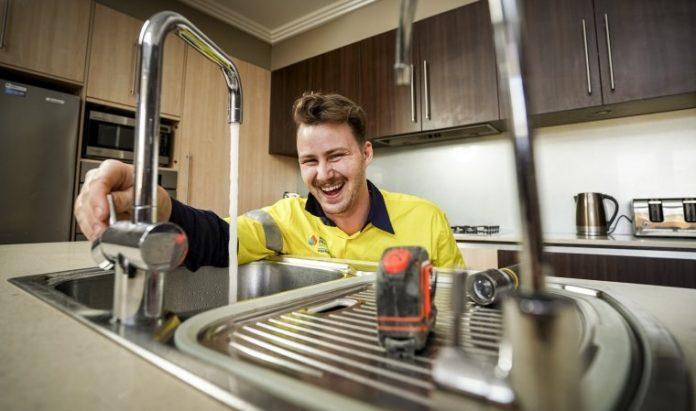 Plumber testing a repaired plumbing system after leak repair in Spokane WA